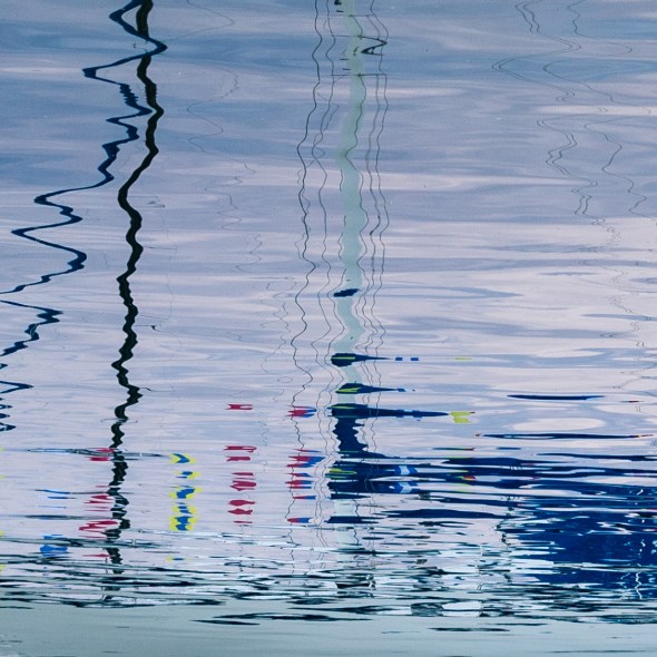 Picture of nautical boat reflections from Balboa Island on Newport Bay, Newport Beach, California, USA.