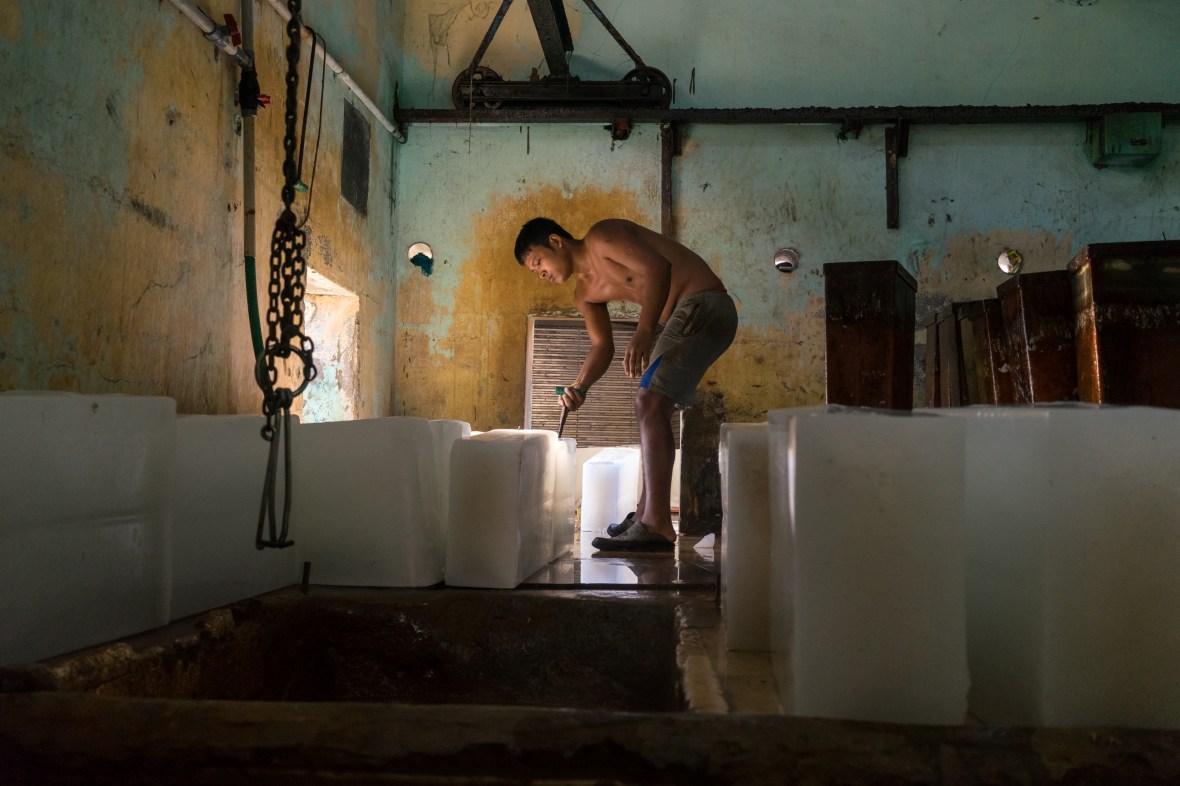 Photography of worker in ice factory in Cochin, Kerala, India by Mary Catherine Messner mcmessner